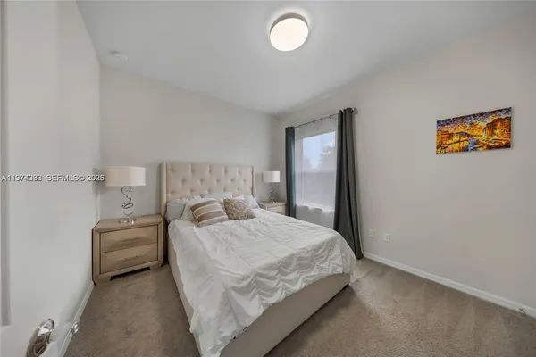 a bedroom with a bed and a lamp