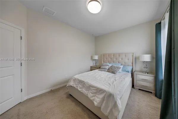 a bedroom with a bed and a lamp