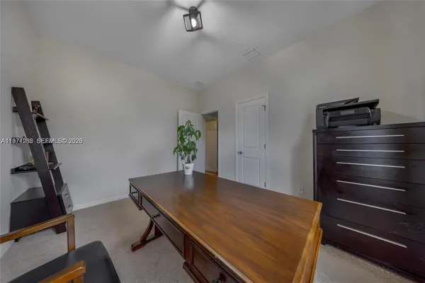 a view of a room with furniture and a window