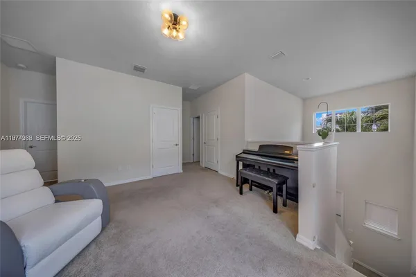 a view of a livingroom with furniture and a window