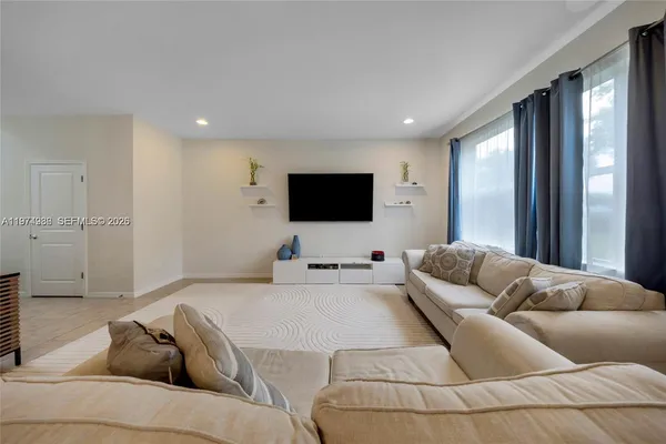 a living room with furniture and a flat screen tv