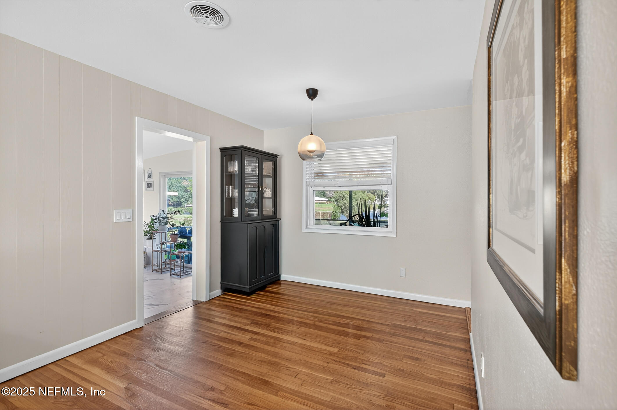 7470 Spinola Road Jacksonville, FL 32217 - Photo 17 of 76 a view of an empty room with window and wooden floor