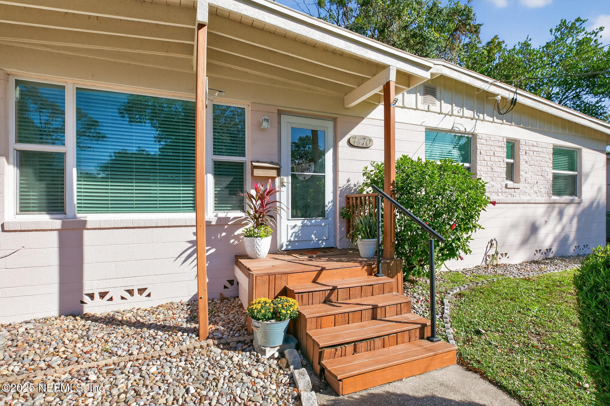 7470 Spinola Road Jacksonville, FL 32217 - Photo 2 of 76 a front view of a house with outdoor seating and plants