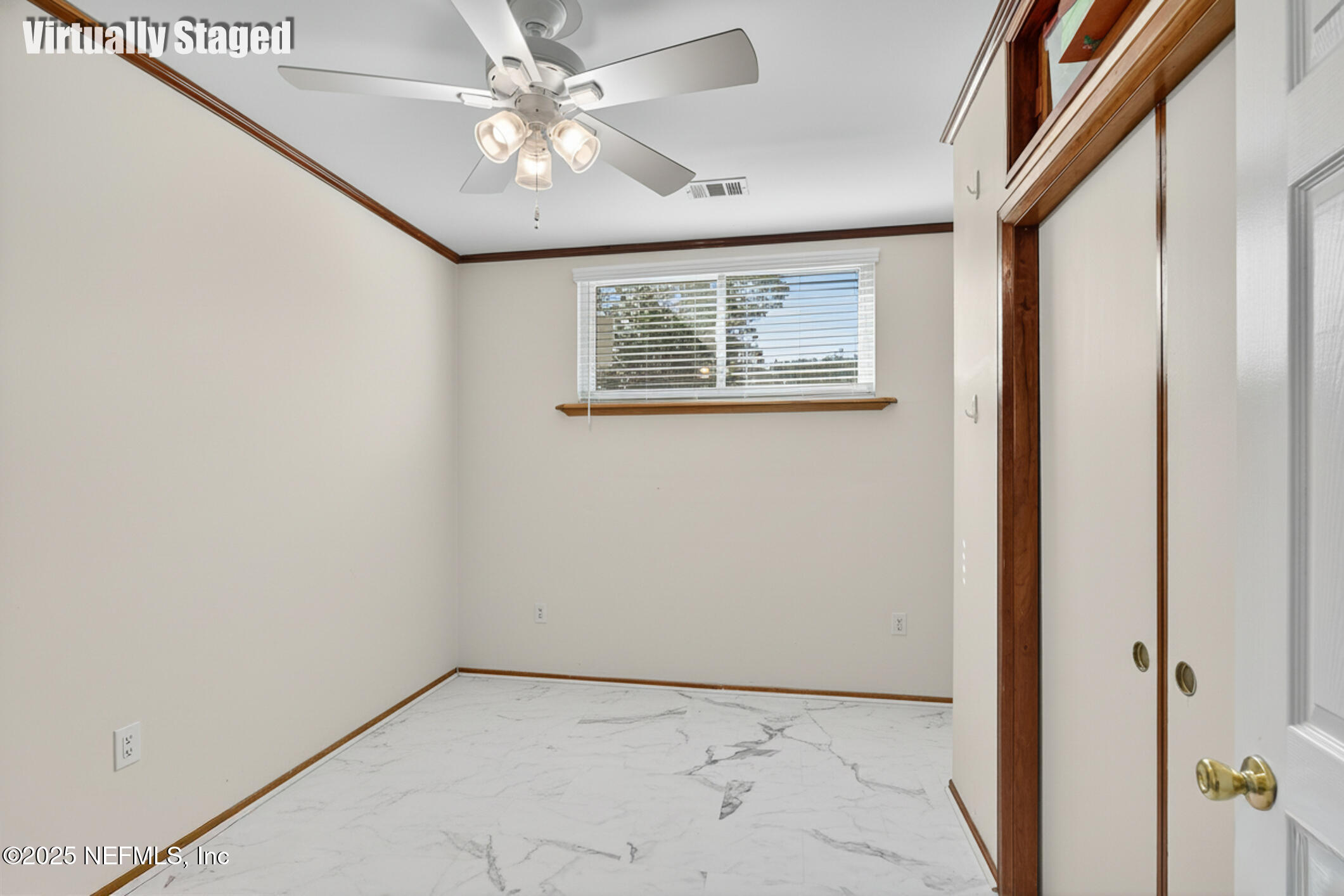 7470 Spinola Road Jacksonville, FL 32217 - Photo 26 of 76 an empty room with windows and fan