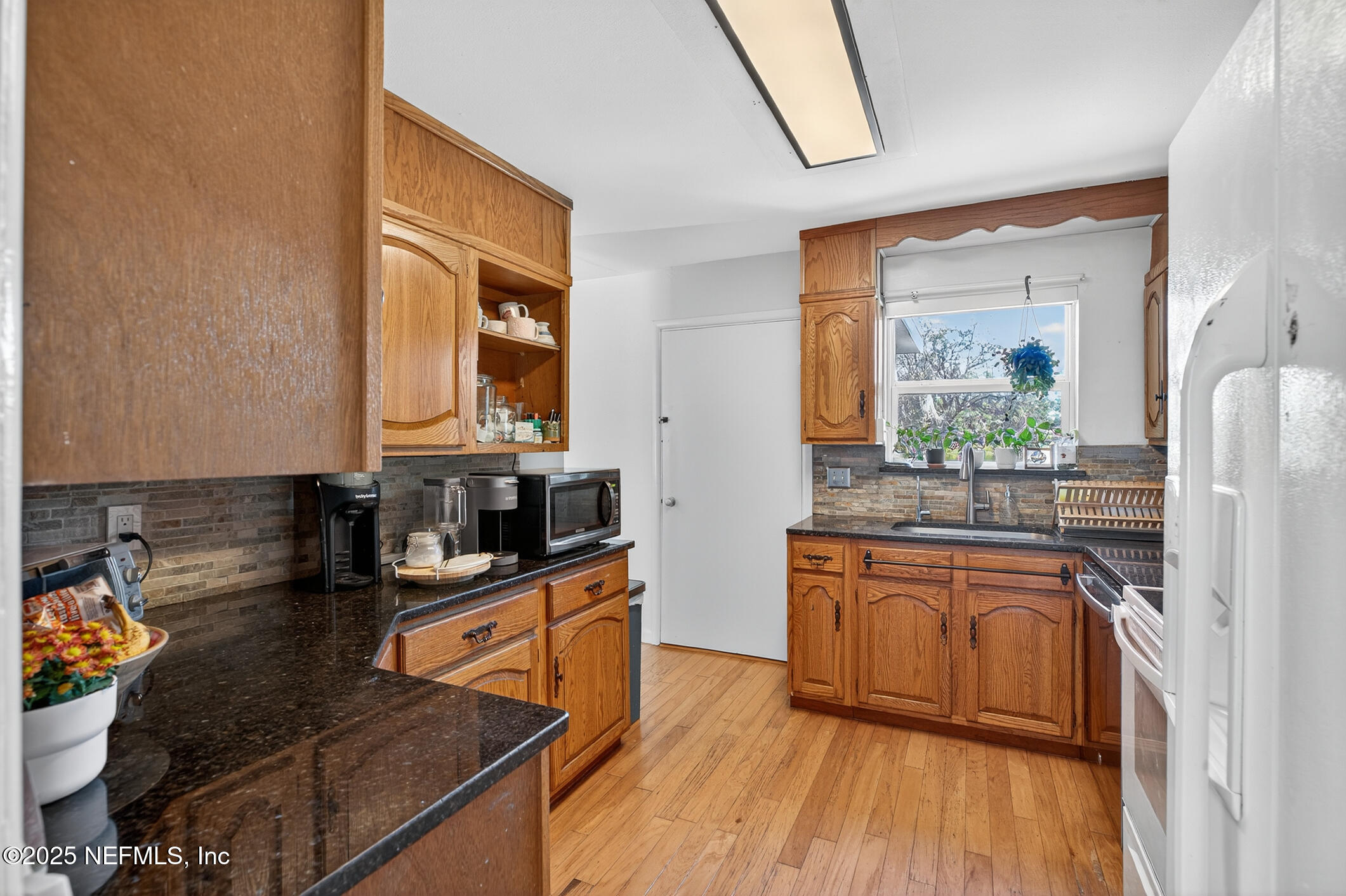 7470 Spinola Road Jacksonville, FL 32217 - Photo 30 of 76 a kitchen with stainless steel appliances granite countertop a stove a sink and a microwave