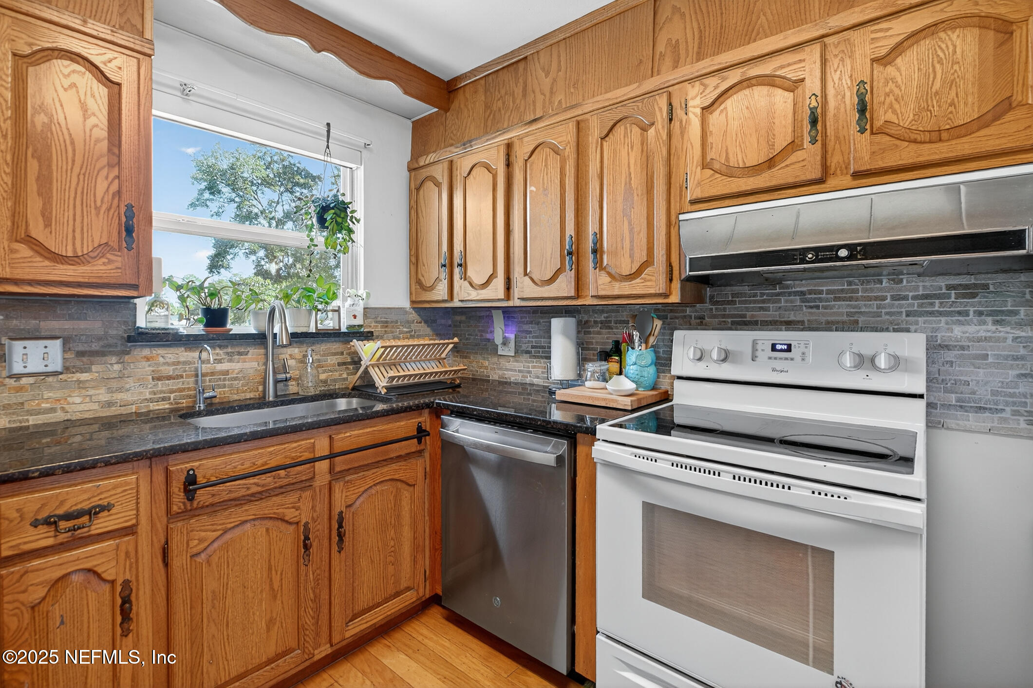 7470 Spinola Road Jacksonville, FL 32217 - Photo 31 of 76 a kitchen with stainless steel appliances granite countertop a stove a sink and cabinets