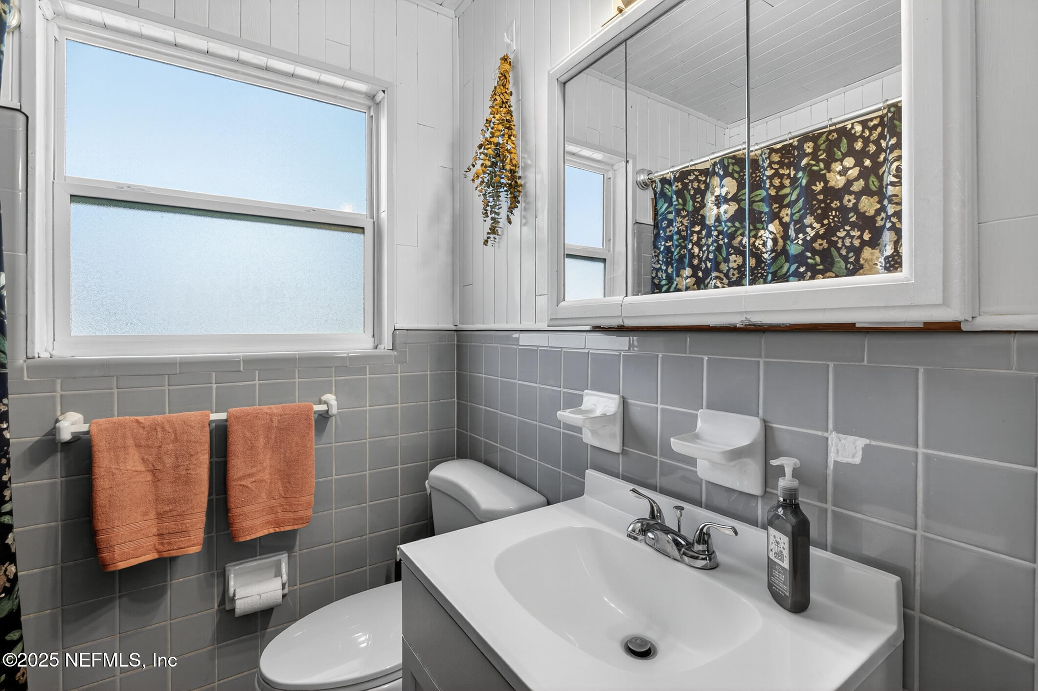 7470 Spinola Road Jacksonville, FL 32217 - Photo 37 of 76 a bathroom with a sink and a mirror