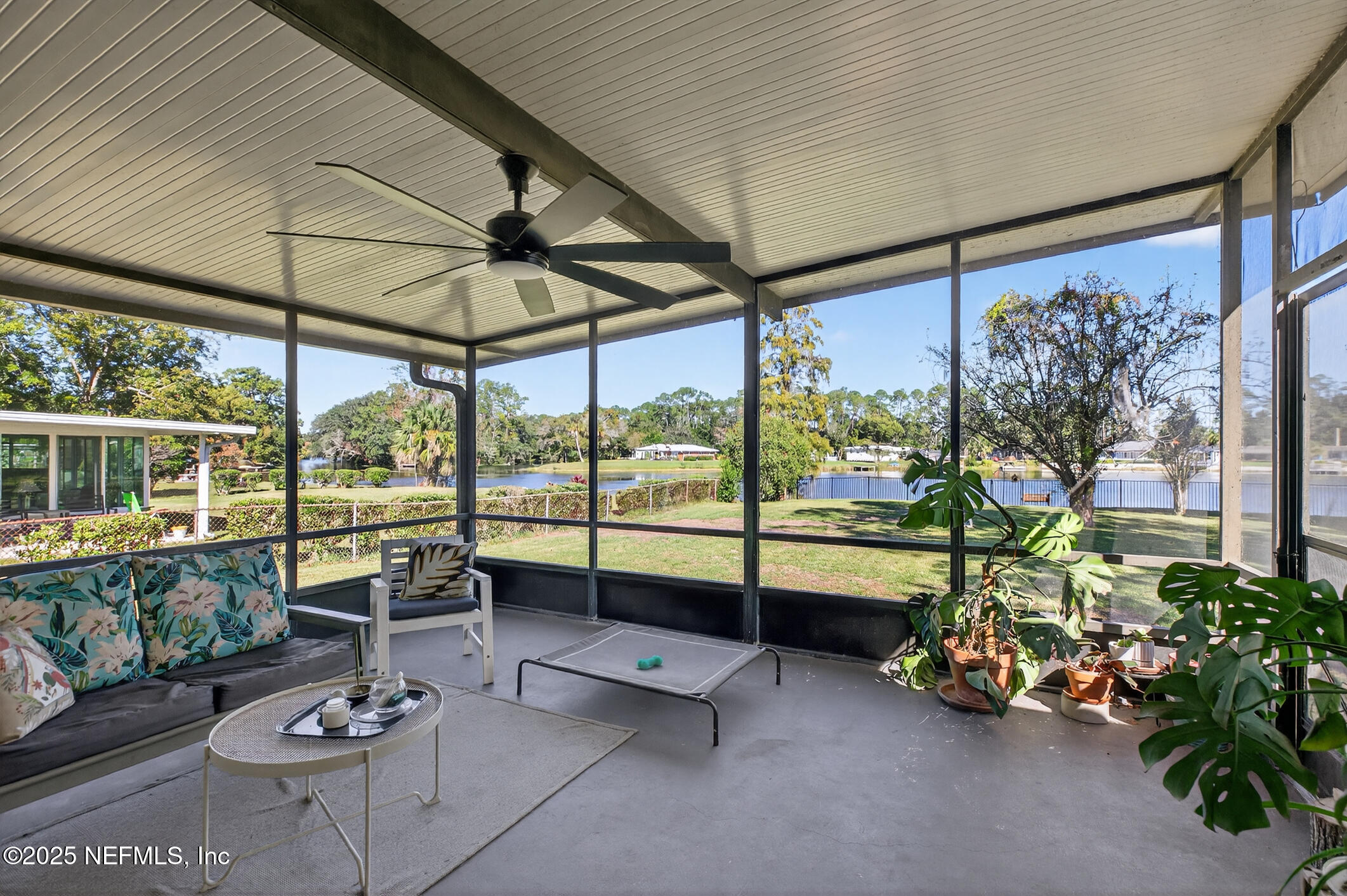 7470 Spinola Road Jacksonville, FL 32217 - Photo 52 of 76 a living room with patio furniture and a potted plants