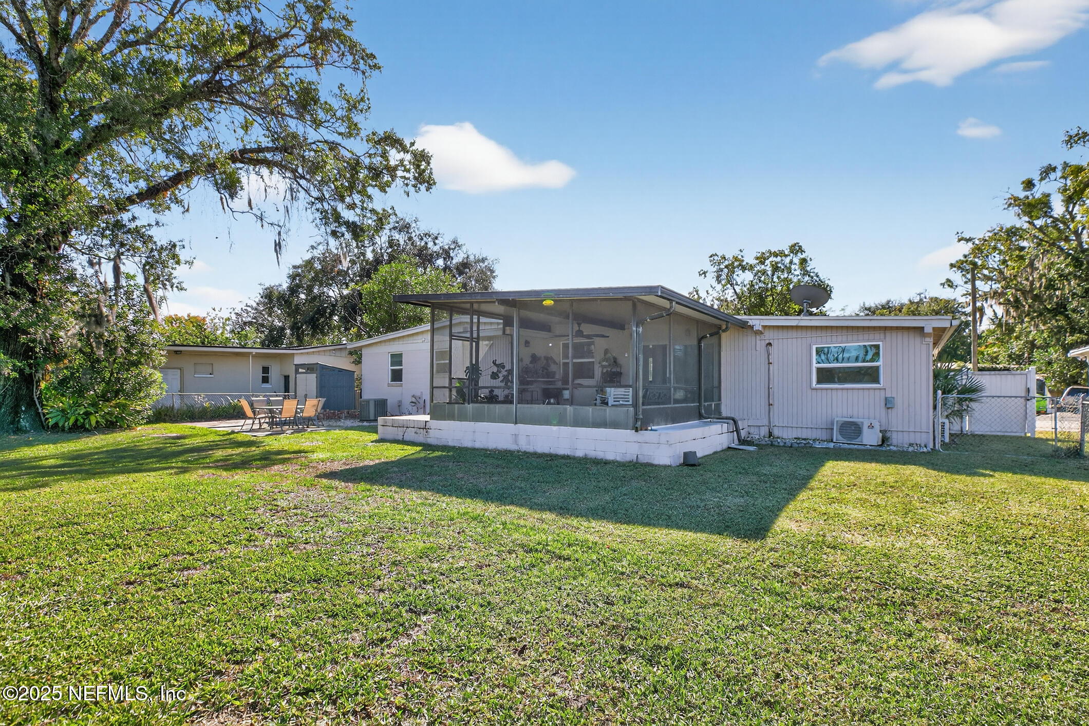 7470 Spinola Road Jacksonville, FL 32217 - Photo 59 of 76 a view of a house with a big yard and a large tree