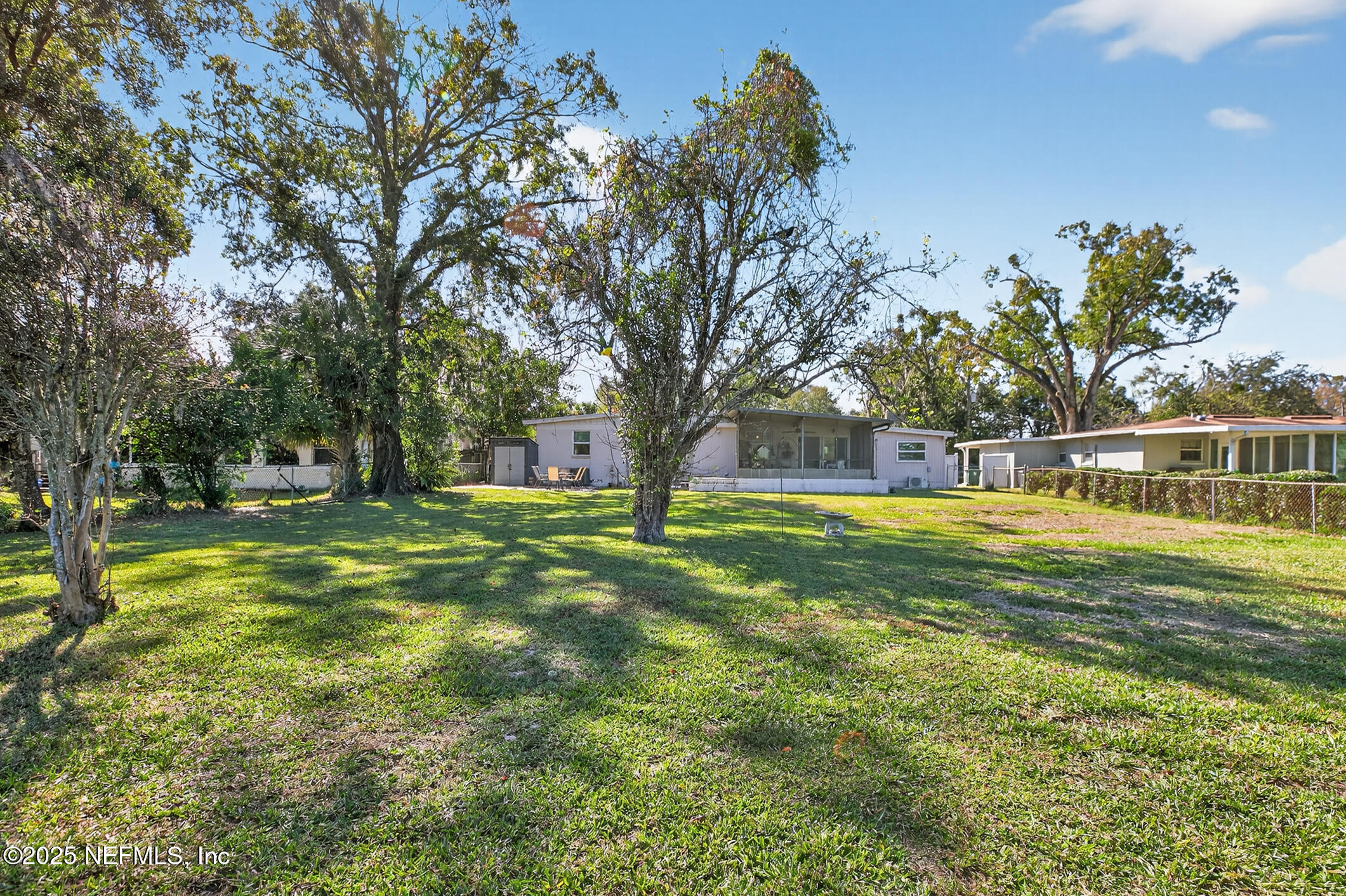 7470 Spinola Road Jacksonville, FL 32217 - Photo 64 of 76 a view of yard with swimming pool and trees in the background