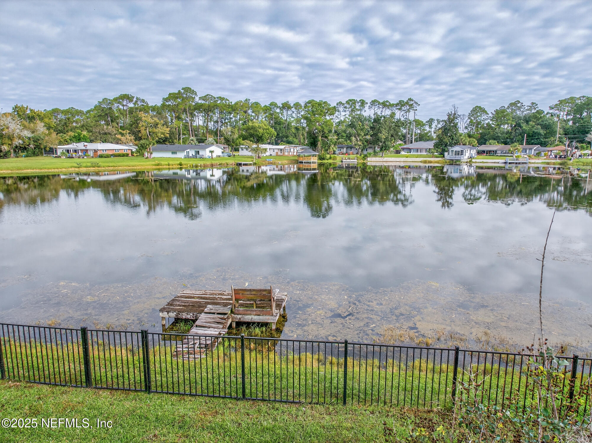 7470 Spinola Road Jacksonville, FL 32217 - Photo 76 of 76 a view of a lake with a houses in the background