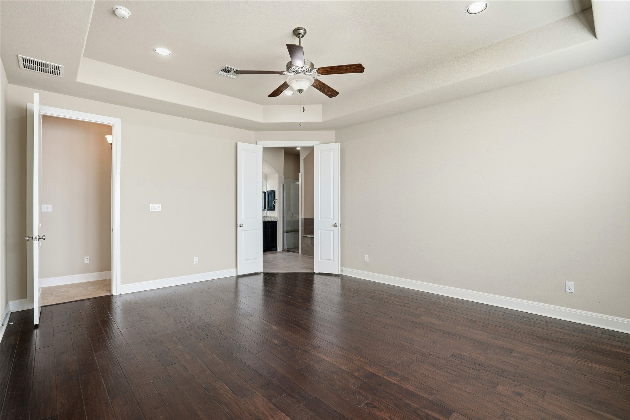 4109 Haight Street Round Rock, TX 78681 - Photo 18 of 40 Bedroom featuring a tray ceiling, wood flooring, ceiling fan