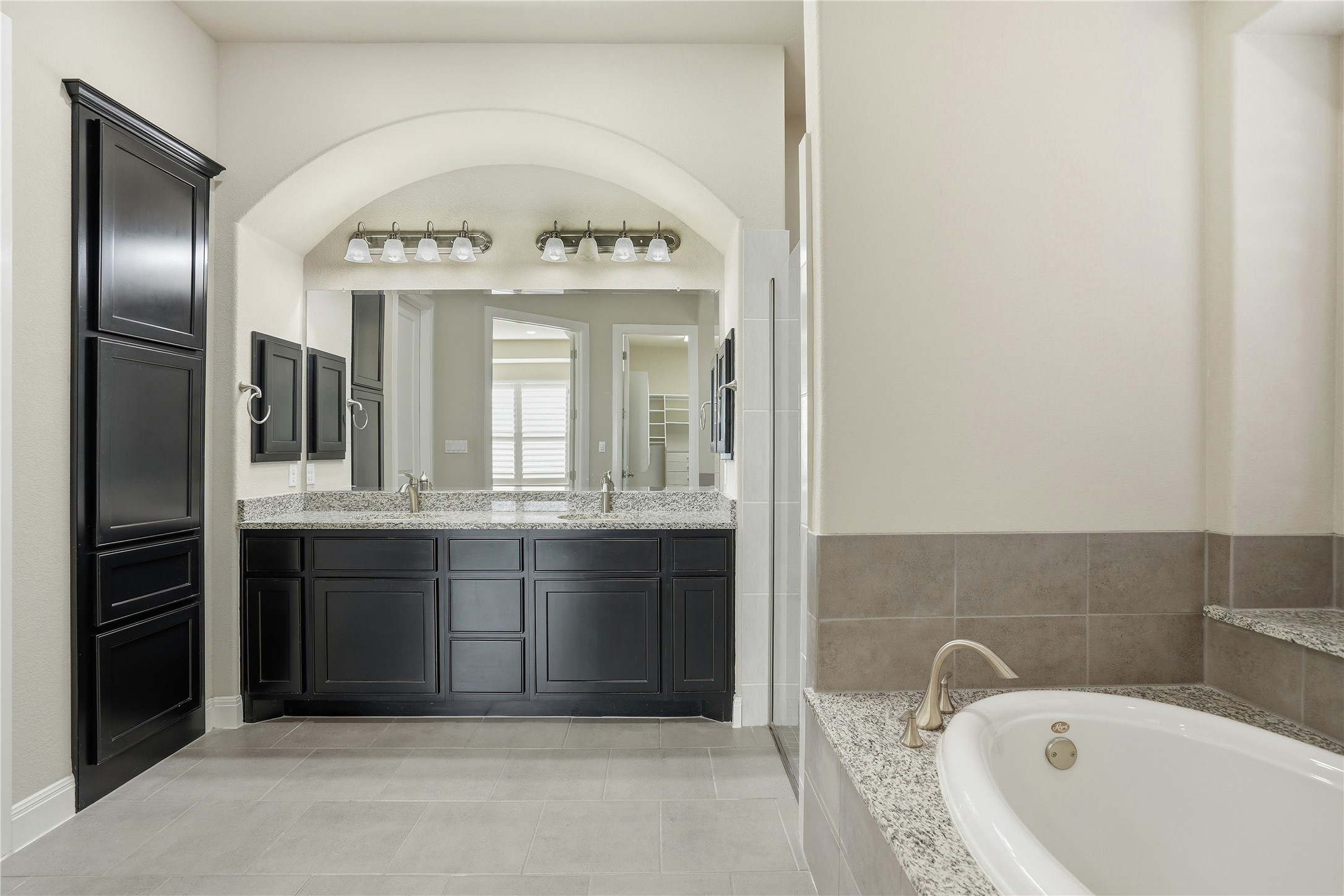 4109 Haight Street Round Rock, TX 78681 - Photo 20 of 40 Full bathroom featuring double vanity, light tile floors, soaking tub and separate shower