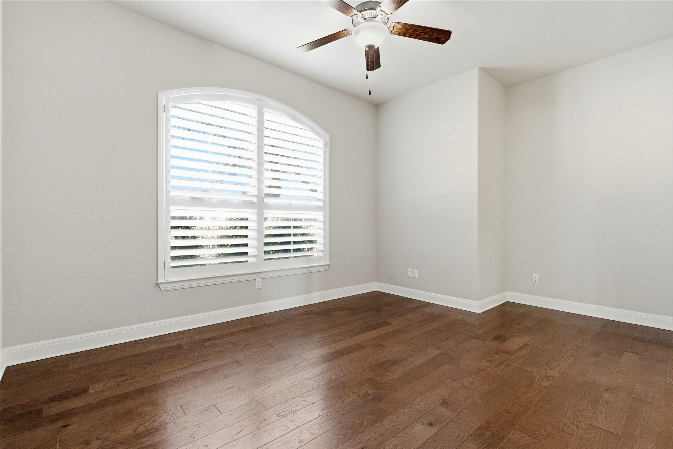 4109 Haight Street Round Rock, TX 78681 - Photo 23 of 40 Secondary bedroom featuring wood flooring, large window with shutters and a ceiling fan