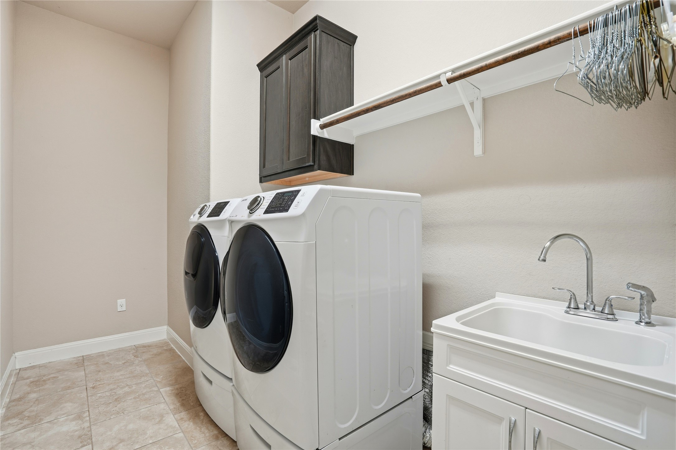 4109 Haight Street Round Rock, TX 78681 - Photo 31 of 40 Laundry room featuring cabinet space and sink