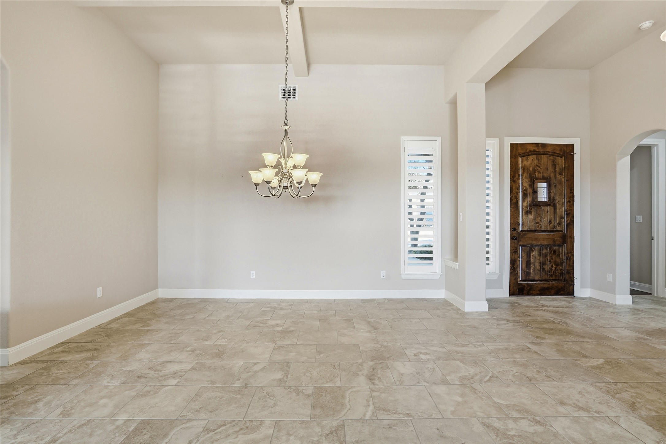 4109 Haight Street Round Rock, TX 78681 - Photo 5 of 40 Foyer entrance featuring arched walkways, beamed ceiling, and a chandelier