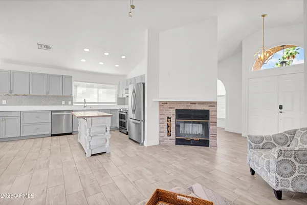 a open kitchen with white cabinets and white appliances