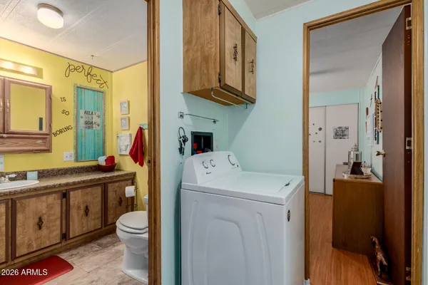a view of bathroom with a toilet sink and mirror