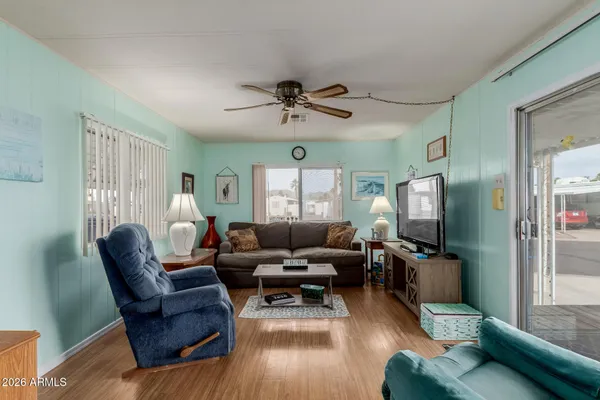 a living room with furniture or wooden floor and a large window