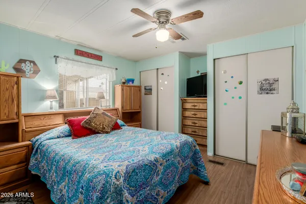 a bedroom with a large bed and a chandelier