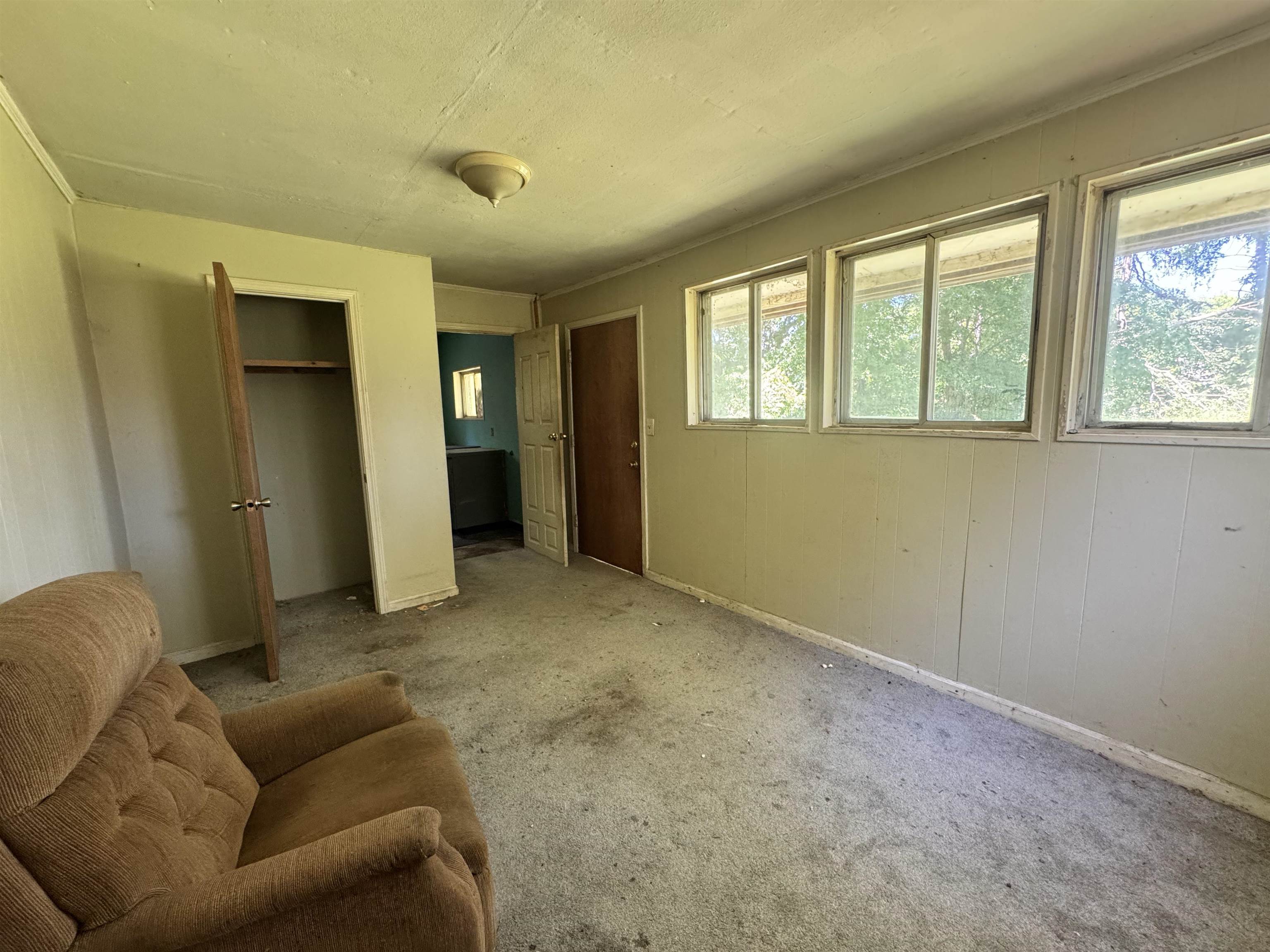 4712 Drummonds Road Drummonds, TN 38023 - Photo 26 of 38 Room featuring multiple windows, a closet with bifold doors, and a ceiling-mounted light fixture