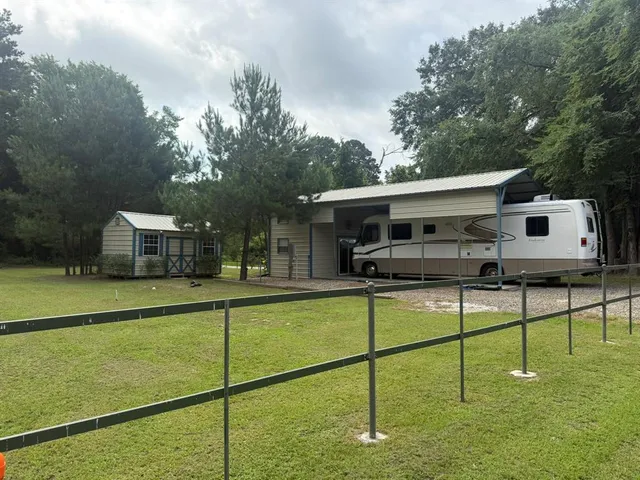 a view of a house with a backyard and a patio