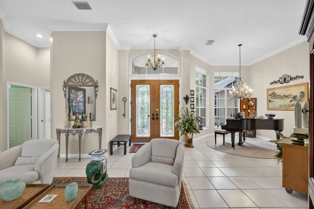 a view of a dining room with furniture a chandelier and wooden floor