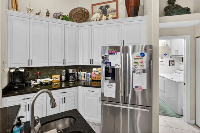 a bathroom with a granite countertop sink a large mirror and a shower