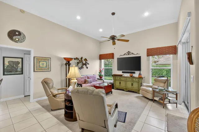 a living room with furniture a rug and a chandelier