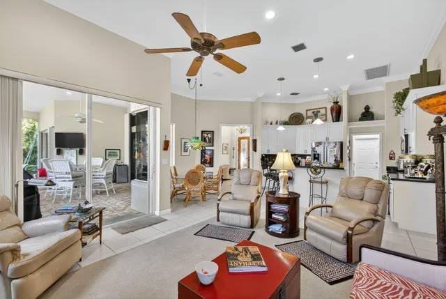 a dining area with furniture and a floor to ceiling window