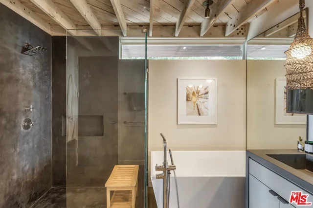 a bathroom with a granite countertop sink a toilet a shower and a mirror