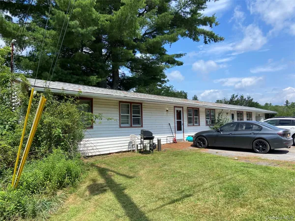 a view of a yard with furniture and a car