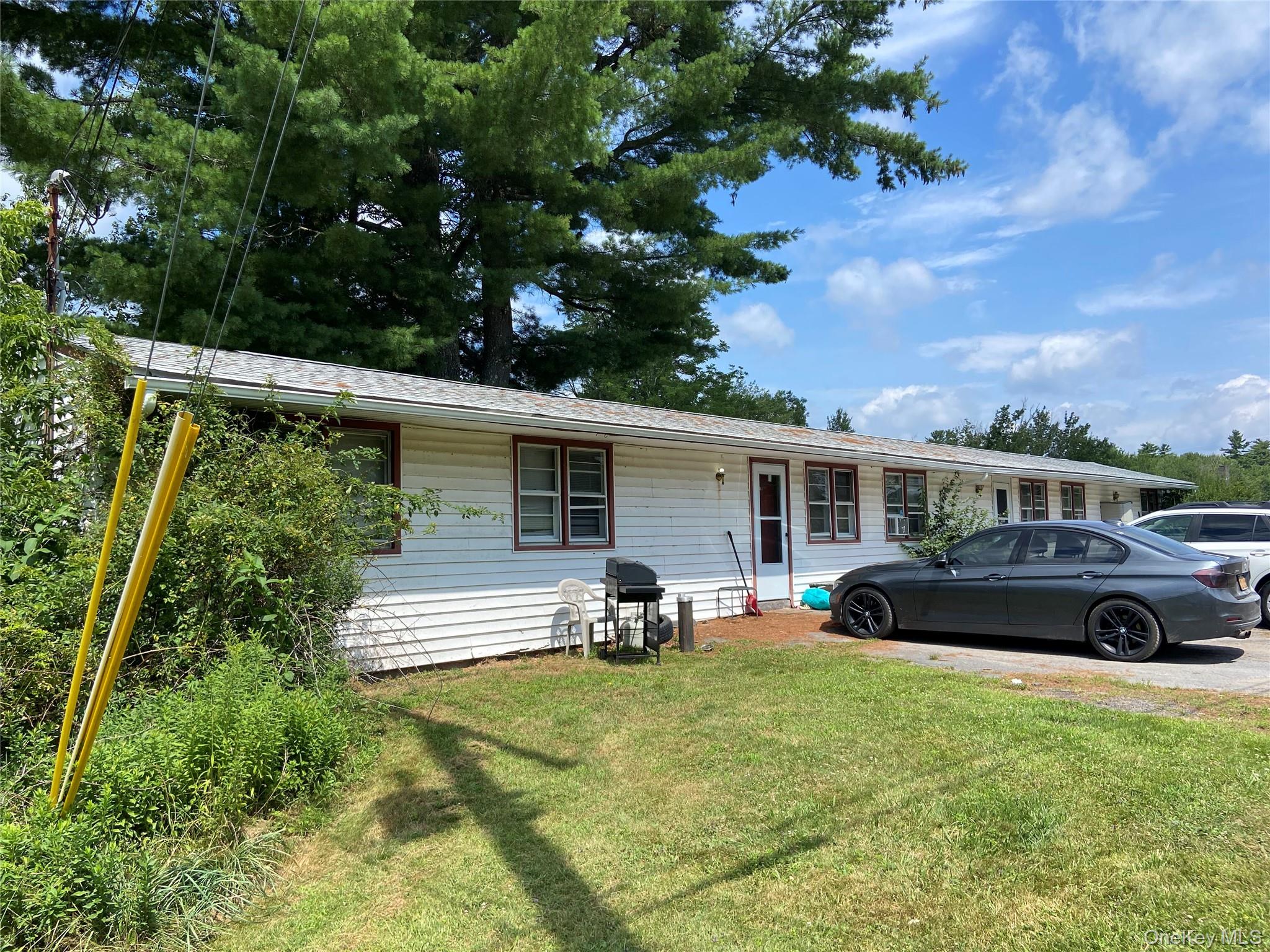 a view of a yard with furniture and a car
