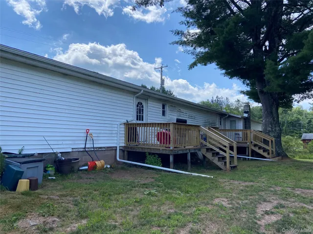 a wooden bench sitting in front of a house