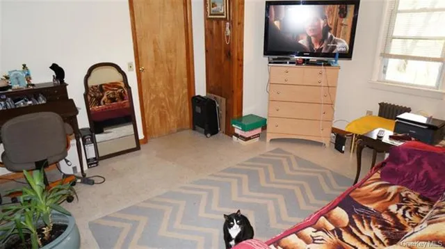 a bed sitting in a bedroom next to a window