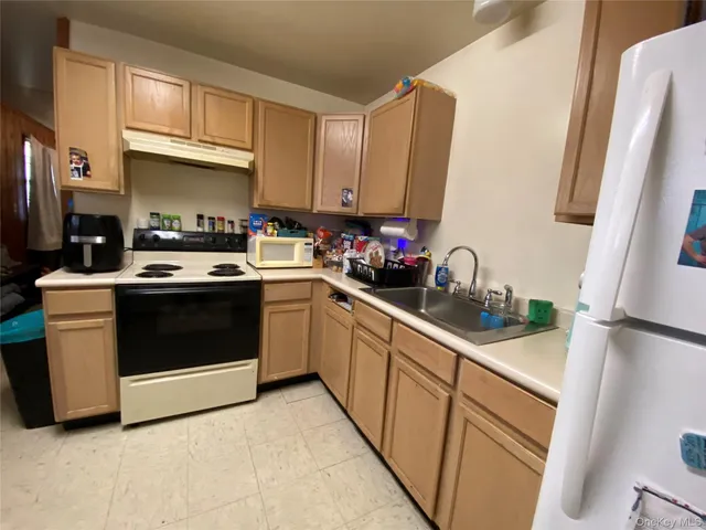 a kitchen with stainless steel appliances a stove a sink and a refrigerator