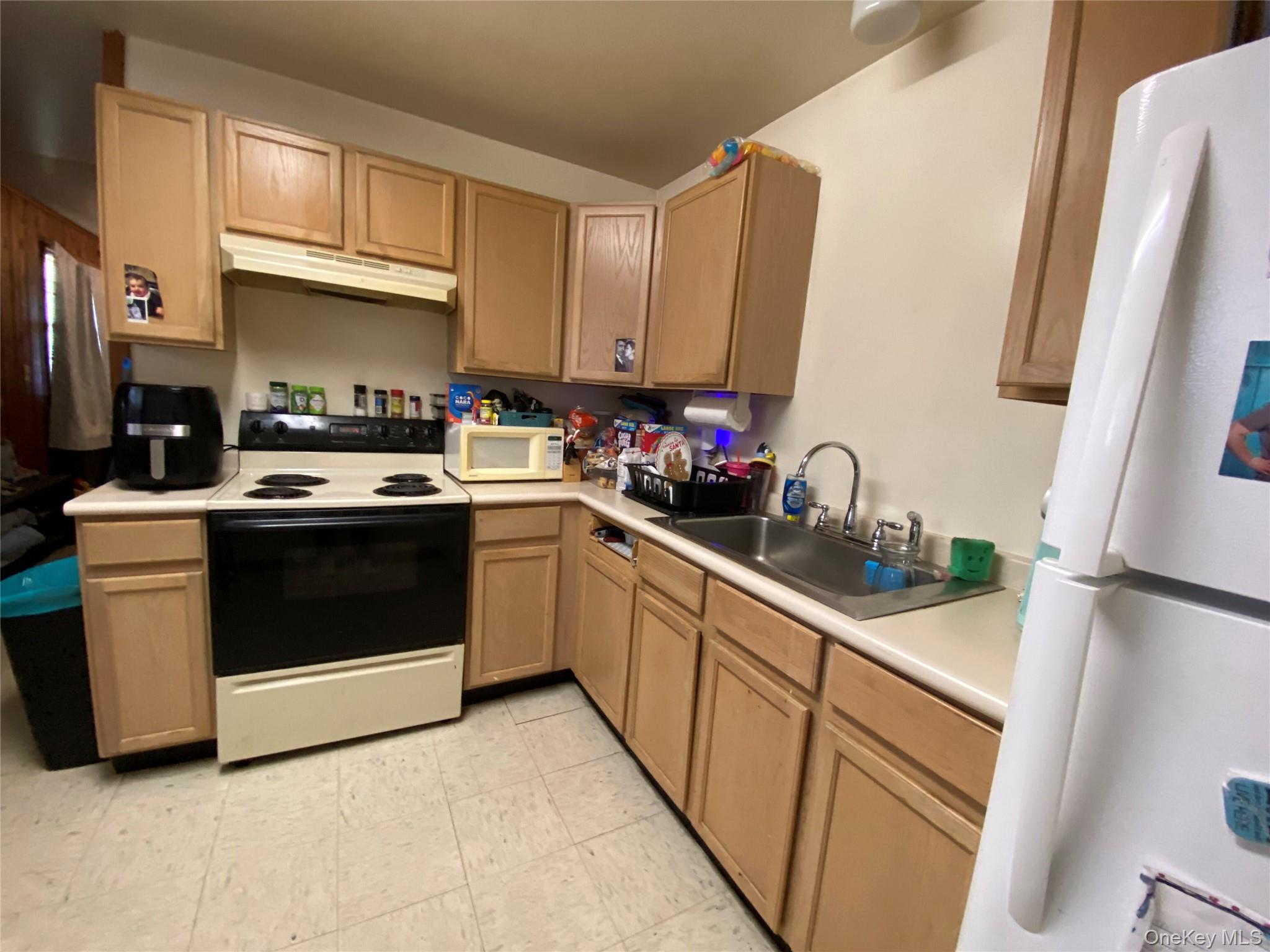 15 Bailey Lake Road Kiamesha Lake, NY 12751 - Photo 4 of 36 a kitchen with stainless steel appliances a stove a sink and a refrigerator