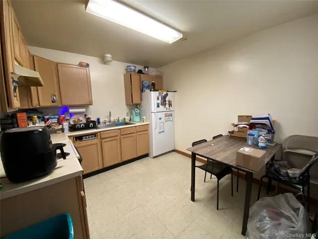 a kitchen with a sink a stove and chairs