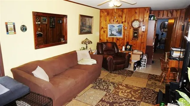 a living room with furniture a lamp and rug