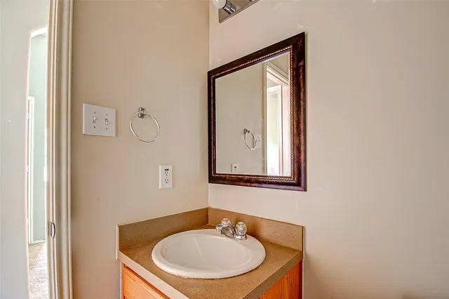 a bathroom with a sink a mirror and a toilet