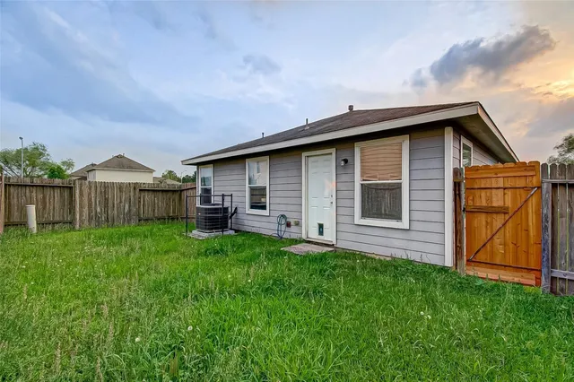 a front view of house with backyard and green space