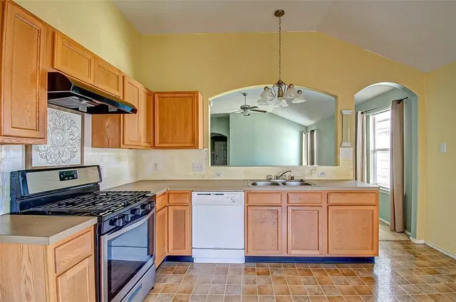a kitchen with a stove and a cabinets