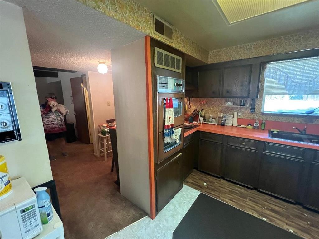 233 Elm Branch Whitney, TX 76692 - Photo 11 of 30 a kitchen with stainless steel appliances granite countertop a refrigerator and a sink