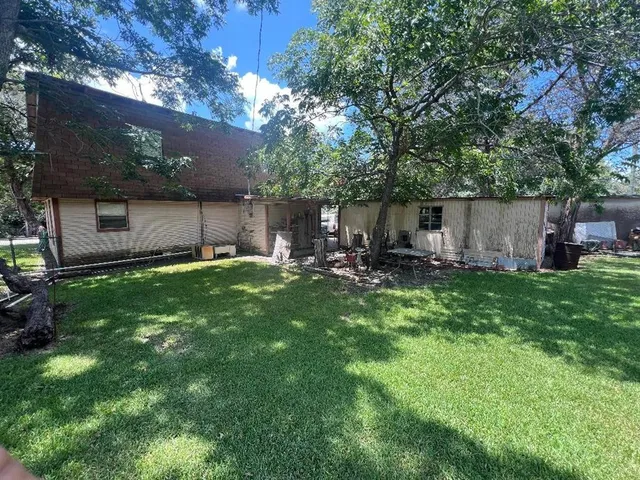 a backyard of a house with table and chairs