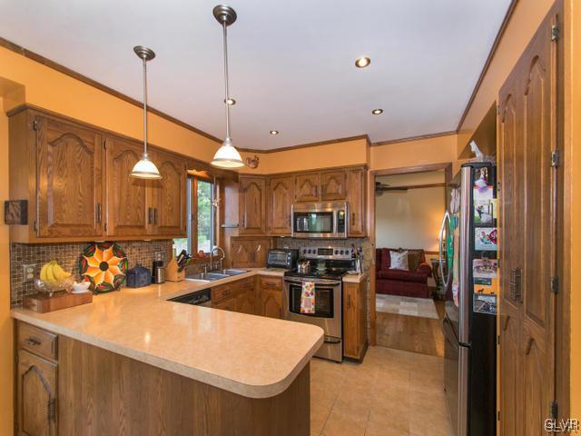 478 Cherry Hill Road Nazareth, PA 18064 - Photo 8 of 28 a kitchen with stainless steel appliances kitchen island granite countertop a sink a stove and a refrigerator
