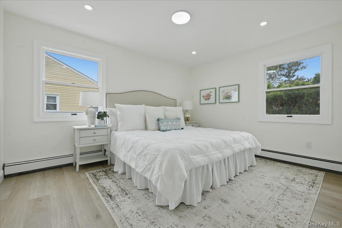 84 North Fordham Road Hicksville, NY 11801 - Photo 11 of 28 a bedroom with a bed and a painting