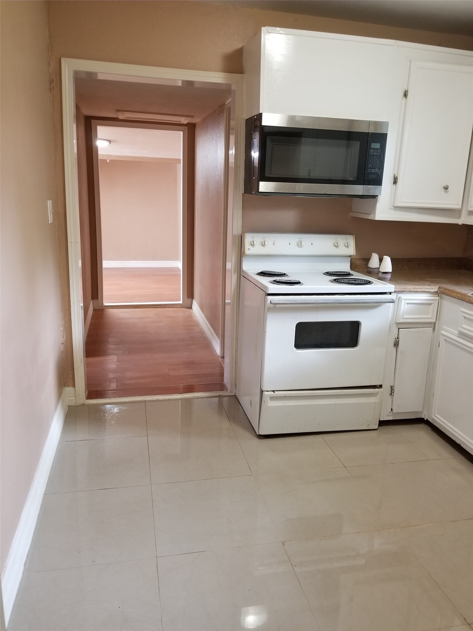 4714 Sharon Street Houston, TX 77020 - Photo 6 of 11 a kitchen with a stove and a microwave