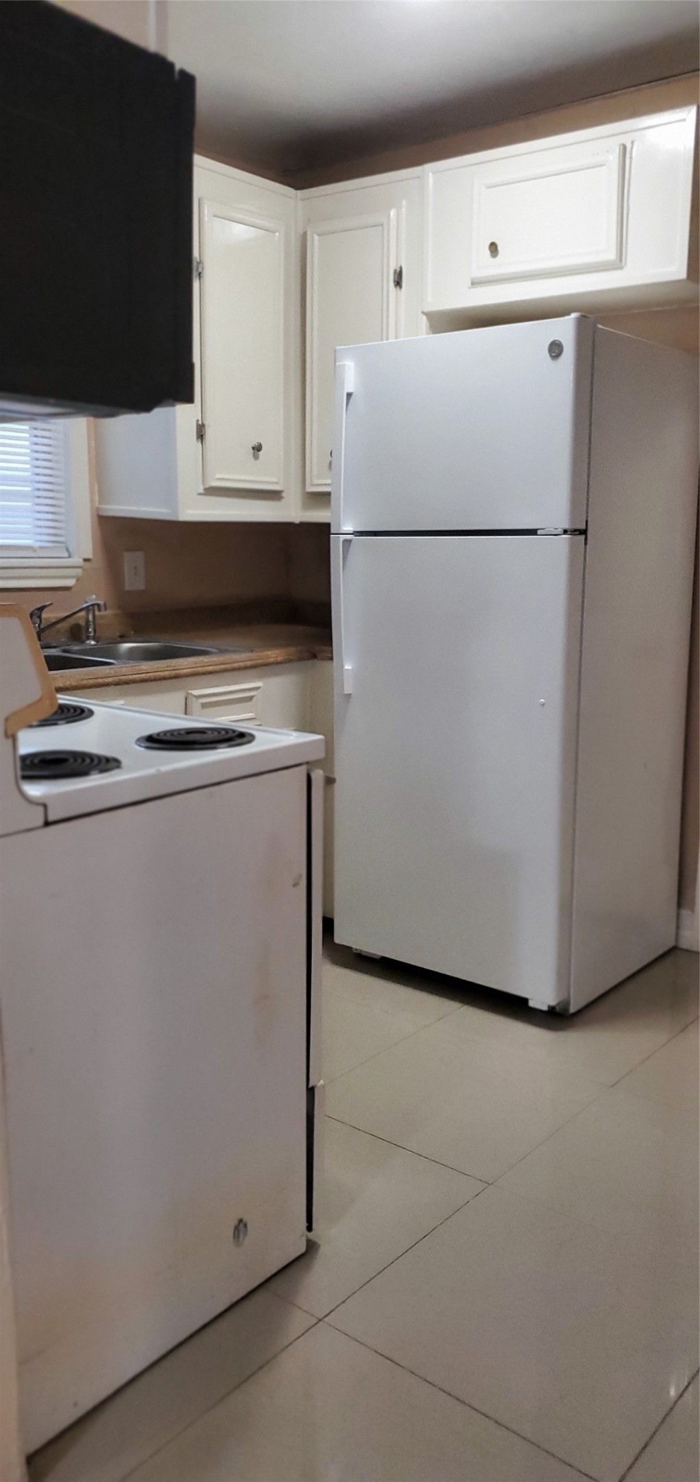 4714 Sharon Street Houston, TX 77020 - Photo 7 of 11 a white refrigerator freezer sitting in a kitchen