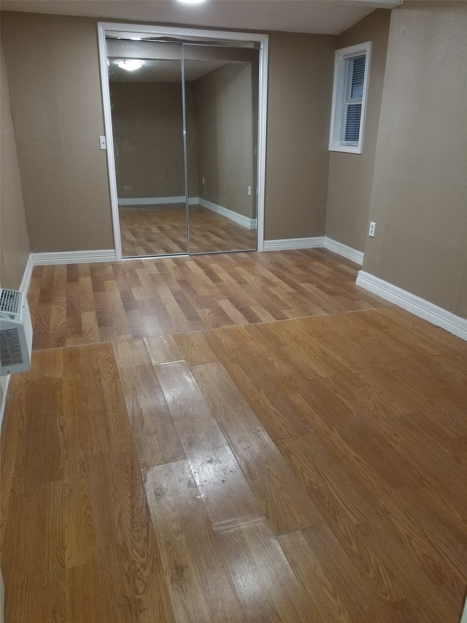 4714 Sharon Street Houston, TX 77020 - Photo 8 of 11 an empty room with wooden floor and mirror
