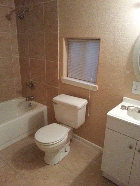 4714 Sharon Street Houston, TX 77020 - Photo 10 of 11 a white toilet sitting next to a bath tub